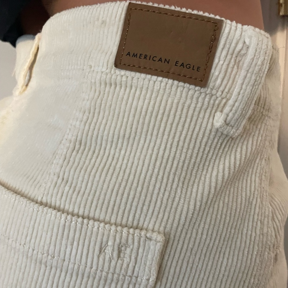 New with tags, American Eagle cream mini skirt, size 12.